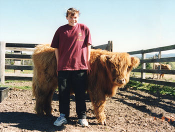 Young girl with a Highland calf