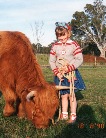 5 year old girl with a young Highland Heifer